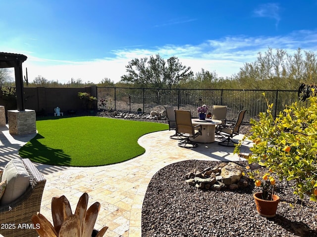 view of yard with an outdoor fire pit, a fenced backyard, and a patio