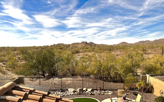 exterior space with fence and a mountain view