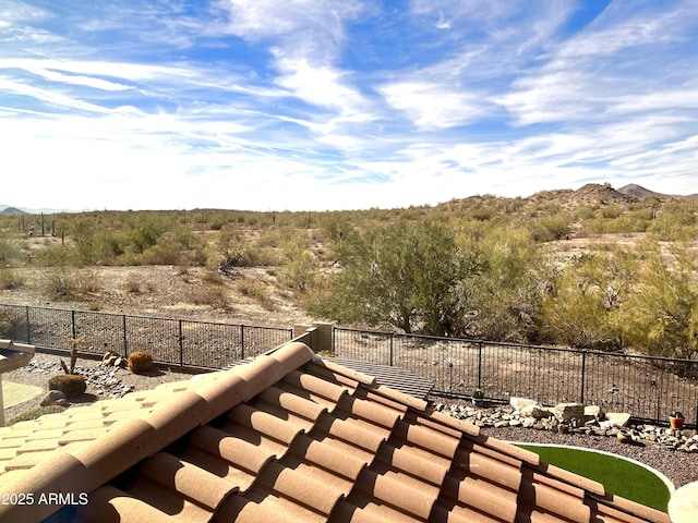 exterior space with fence and a mountain view