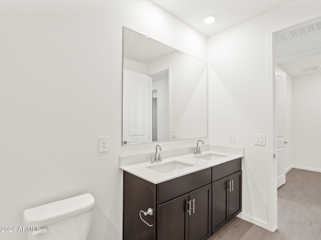 bathroom featuring hardwood / wood-style floors, vanity, and toilet