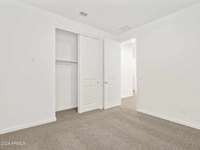 unfurnished bedroom with carpet floors and a closet