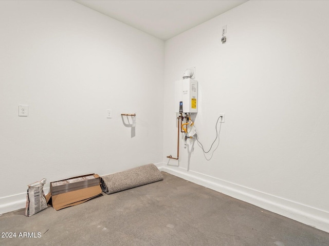 laundry area with water heater and carpet