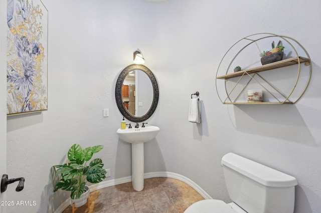 bathroom featuring tile patterned floors and toilet