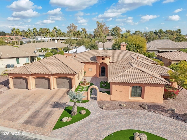 mediterranean / spanish-style home with a garage