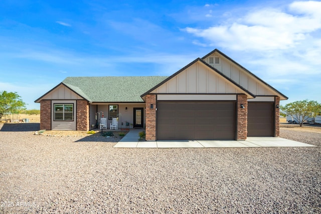 ranch-style home featuring a porch, a garage, board and batten siding, brick siding, and gravel driveway