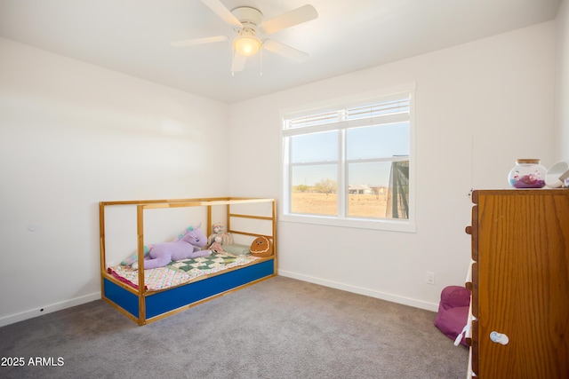 carpeted bedroom featuring a ceiling fan and baseboards