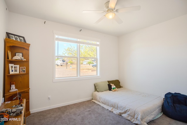 carpeted bedroom featuring ceiling fan and baseboards