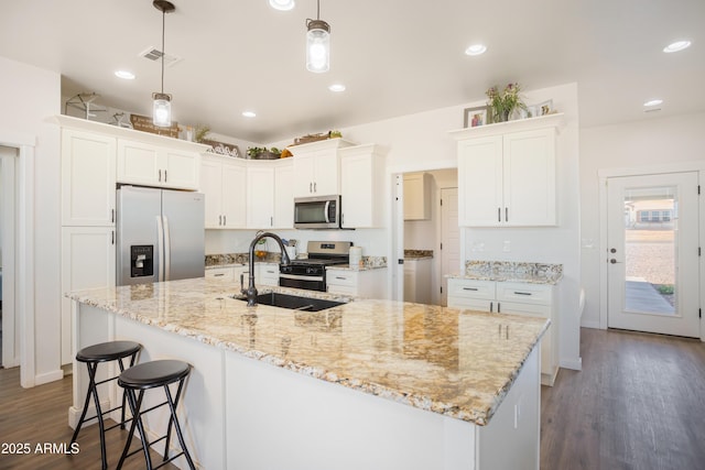 kitchen featuring dark wood finished floors, visible vents, stainless steel appliances, and white cabinetry