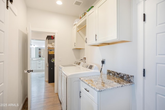 laundry area with recessed lighting, cabinet space, independent washer and dryer, light wood-type flooring, and visible vents