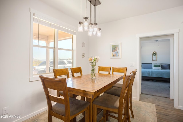dining space featuring wood finished floors and baseboards