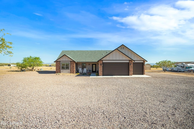 single story home featuring driveway, a garage, board and batten siding, and brick siding