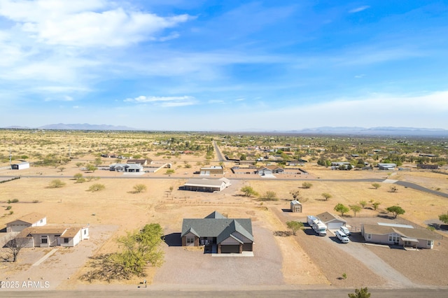 bird's eye view with a rural view, view of desert, and a mountain view