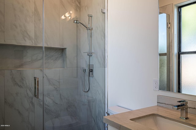 full bathroom with vanity, a marble finish shower, and toilet