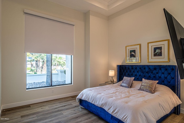 bedroom with wood finished floors and baseboards