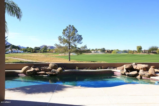 pool featuring a lawn and a mountain view