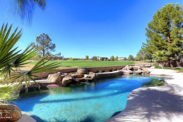 outdoor pool with a patio and a lawn