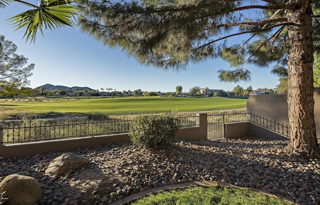 view of community with fence and a mountain view