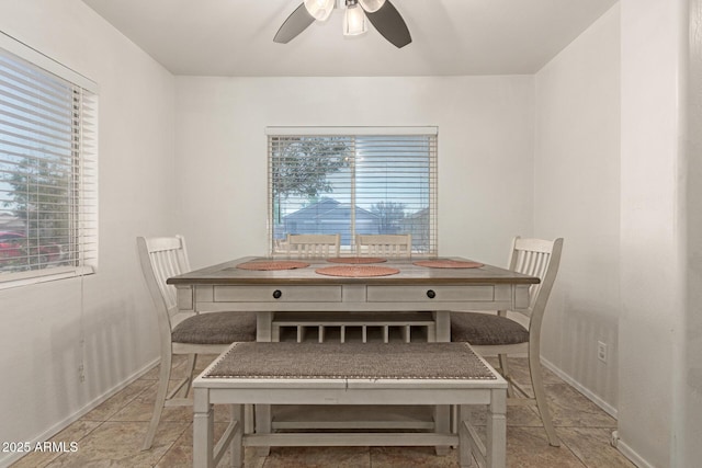 dining area with baseboards and ceiling fan