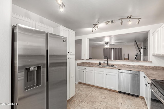 kitchen featuring visible vents, a sink, appliances with stainless steel finishes, and white cabinets