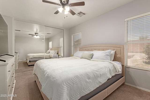 bedroom featuring visible vents, baseboards, ceiling fan, and light carpet