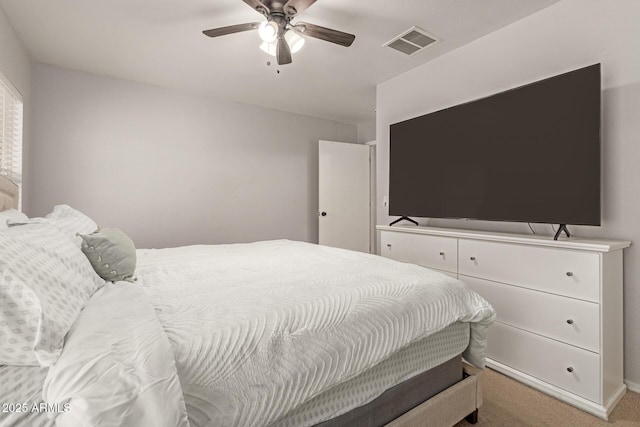 bedroom featuring a ceiling fan, light colored carpet, and visible vents