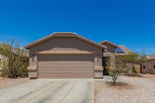 ranch-style house with a tiled roof, an attached garage, concrete driveway, and stucco siding