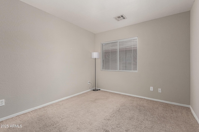 carpeted empty room with baseboards and visible vents