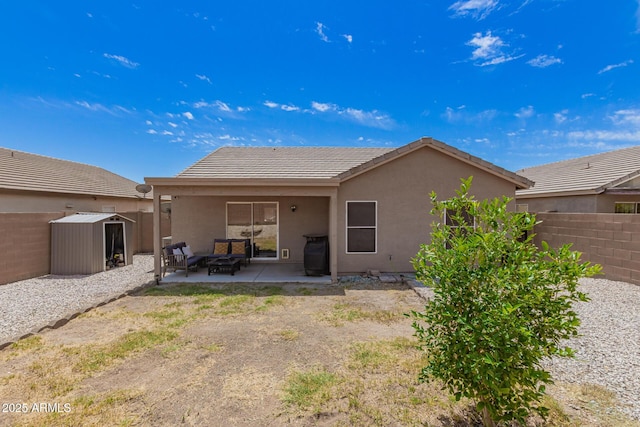 rear view of property with a storage shed, stucco siding, a fenced backyard, an outbuilding, and a patio