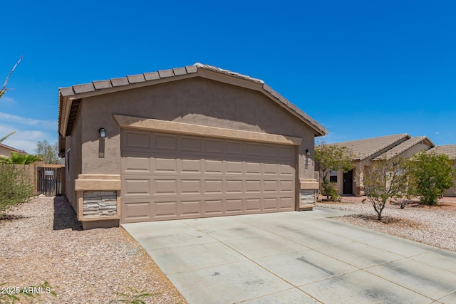 single story home featuring a garage, fence, stucco siding, and concrete driveway