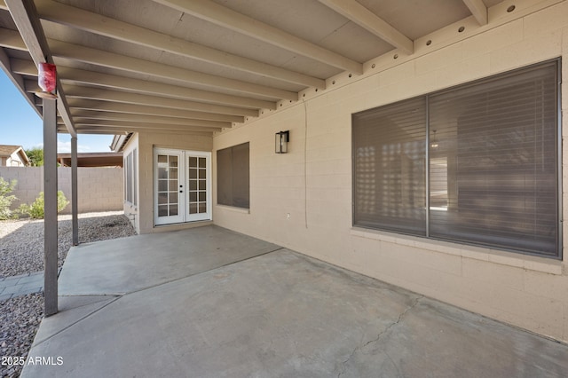 view of patio featuring fence and french doors