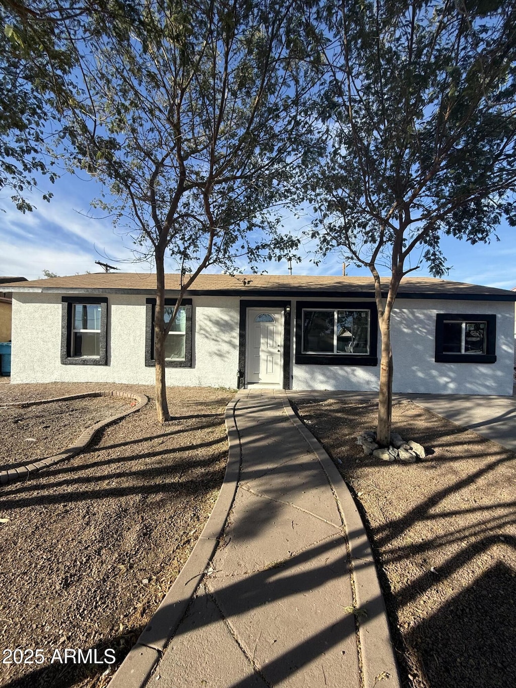 ranch-style home featuring stucco siding