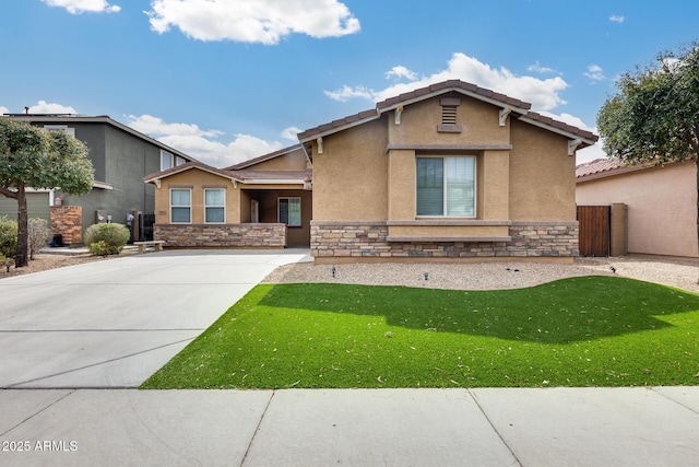 view of front facade featuring stone siding, a front yard, a tile roof, and stucco siding