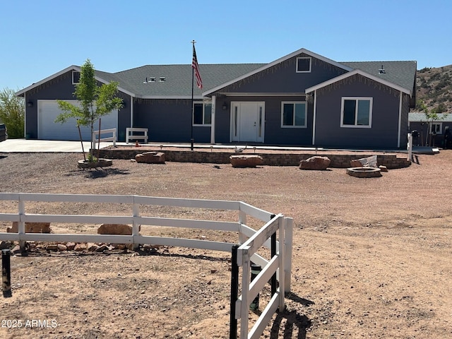single story home with a garage, fence, and dirt driveway