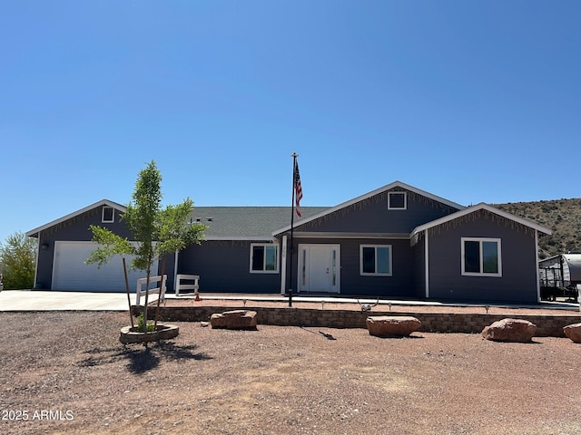 ranch-style house with concrete driveway and a garage