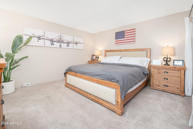 bedroom with light colored carpet