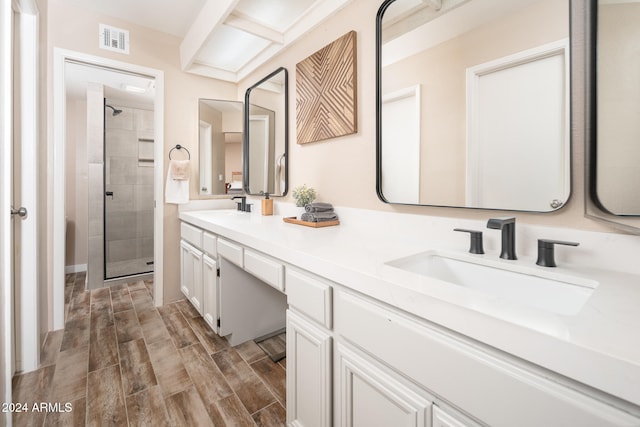 bathroom featuring vanity, wood-type flooring, and a shower with shower door