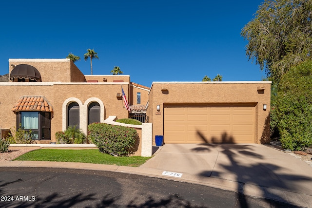 adobe home featuring a garage