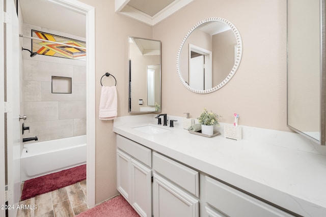 bathroom with vanity, ornamental molding, tiled shower / bath combo, and hardwood / wood-style flooring