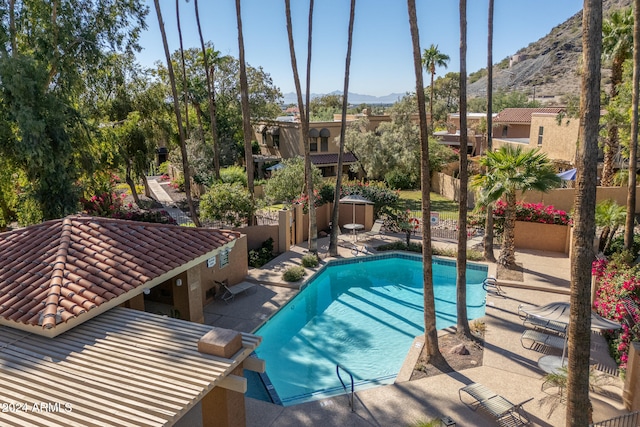 view of swimming pool featuring a mountain view and a patio area