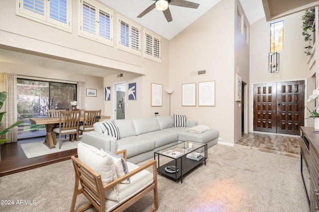 living room featuring high vaulted ceiling, wood-type flooring, and ceiling fan