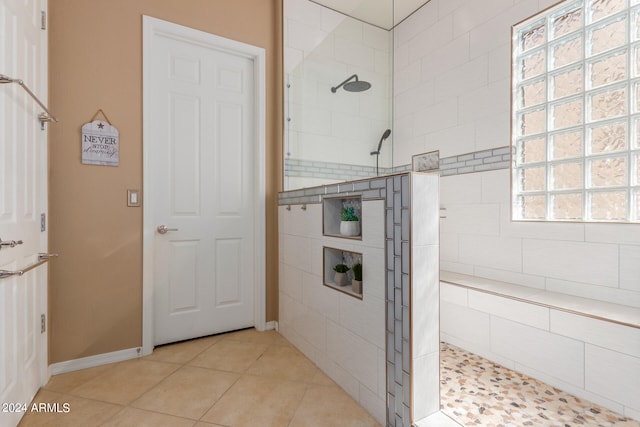 bathroom featuring tile patterned flooring and tiled shower