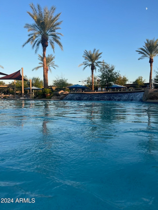 view of pool featuring a water view