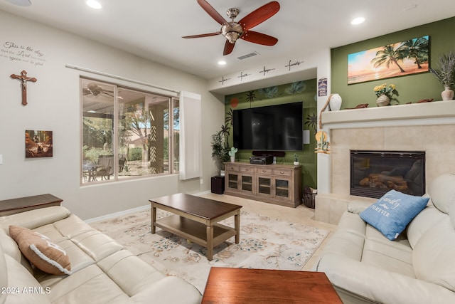 living room with ceiling fan and a fireplace