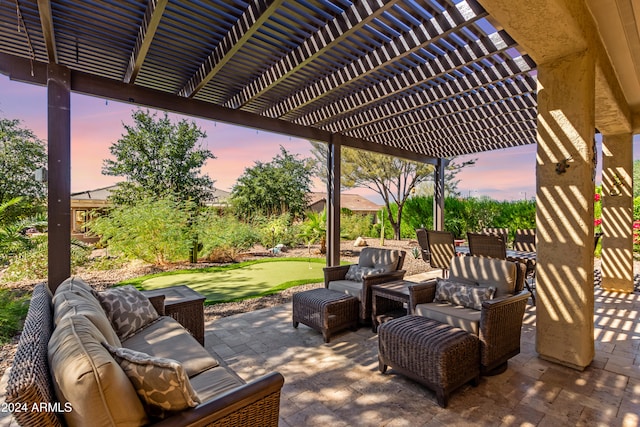 patio terrace at dusk featuring a pergola and an outdoor hangout area