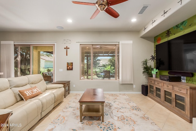 tiled living room featuring a healthy amount of sunlight and ceiling fan