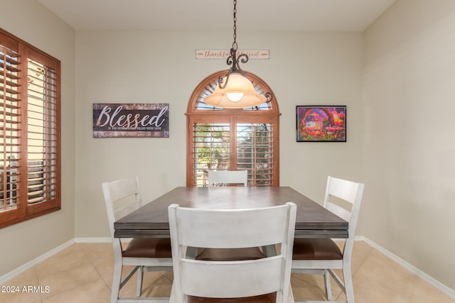 dining area with a wealth of natural light and light tile patterned floors