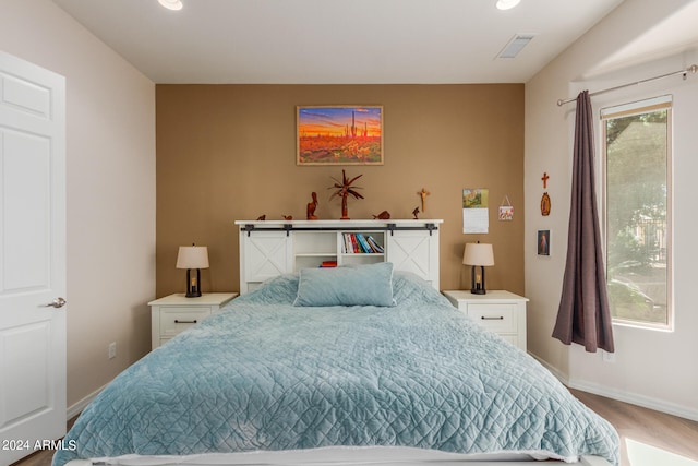 bedroom with hardwood / wood-style flooring