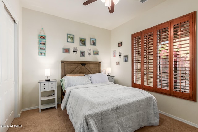 carpeted bedroom with a closet and ceiling fan