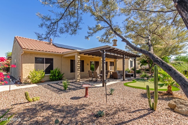 rear view of house with a patio and a pergola