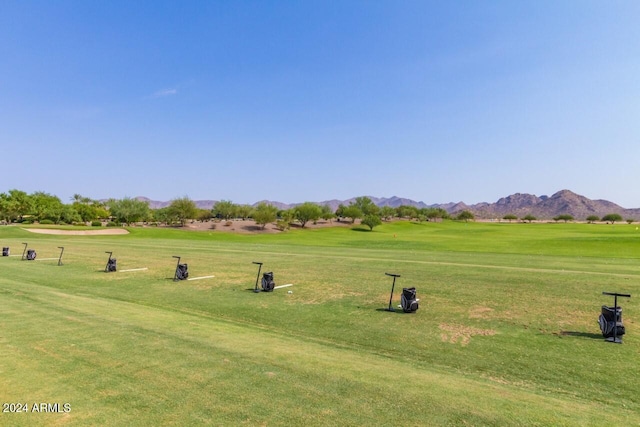 surrounding community featuring a mountain view and a lawn